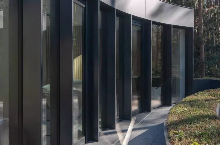 The framework for the glass is graphite fiber-cement panels and sheet metal
