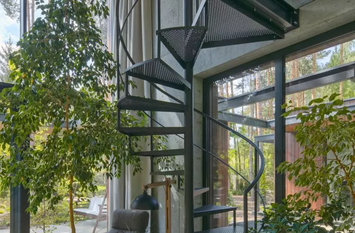 A spiral staircase leads to the mezzanine where the office space is located