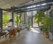 view from the dining room to the lounge area and the spiral staircase leading to the mezzanine floor