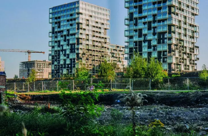in the background of the completed buildings, you can see the next stages of the investment being built