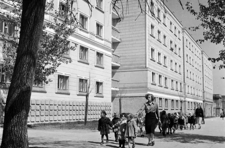 A group of kindergarten children with their chaperones walk along Swierczewskiego (Solidarity) Avenue, Warsaw, May 1, 1952.