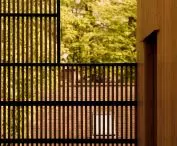 Here and there, the wooden facade has gaps, and the openwork screens allow light to reach the hidden terraces