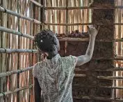 a teenager participating in the construction of a planned temporary shelter