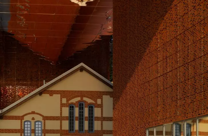 unusual shape resembles a bridge stretched over a historic power plant building 
