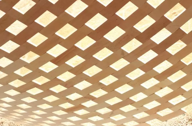 The use of wood in the installation is part of a series of experiments by the studio involving “fabrics” constructed from rigid elements