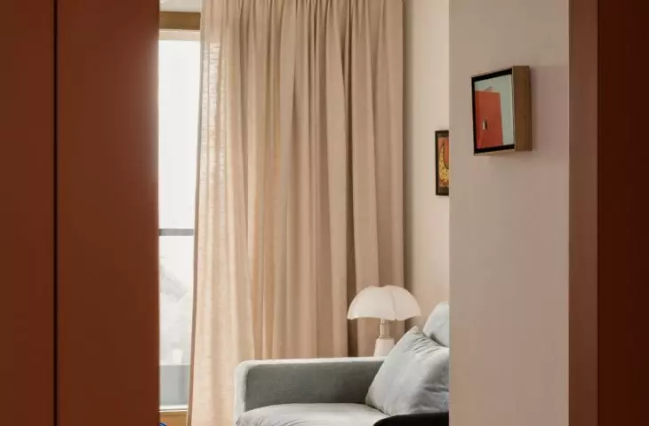 Viewed from the hallway, the living room shows that bold colors are used sparingly here, but very deliberately