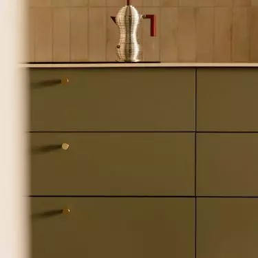 The countertop coffee maker fits right in with the character of the apartment, where functionality meets a love of design.