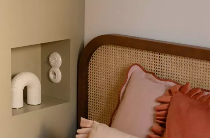 In the bedroom, sage green meets woven textures, wood, and powdery fabrics