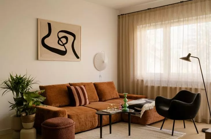 The mid-century vibe is most evident in the living room—in its rounded shapes, wooden furniture, and decorative details