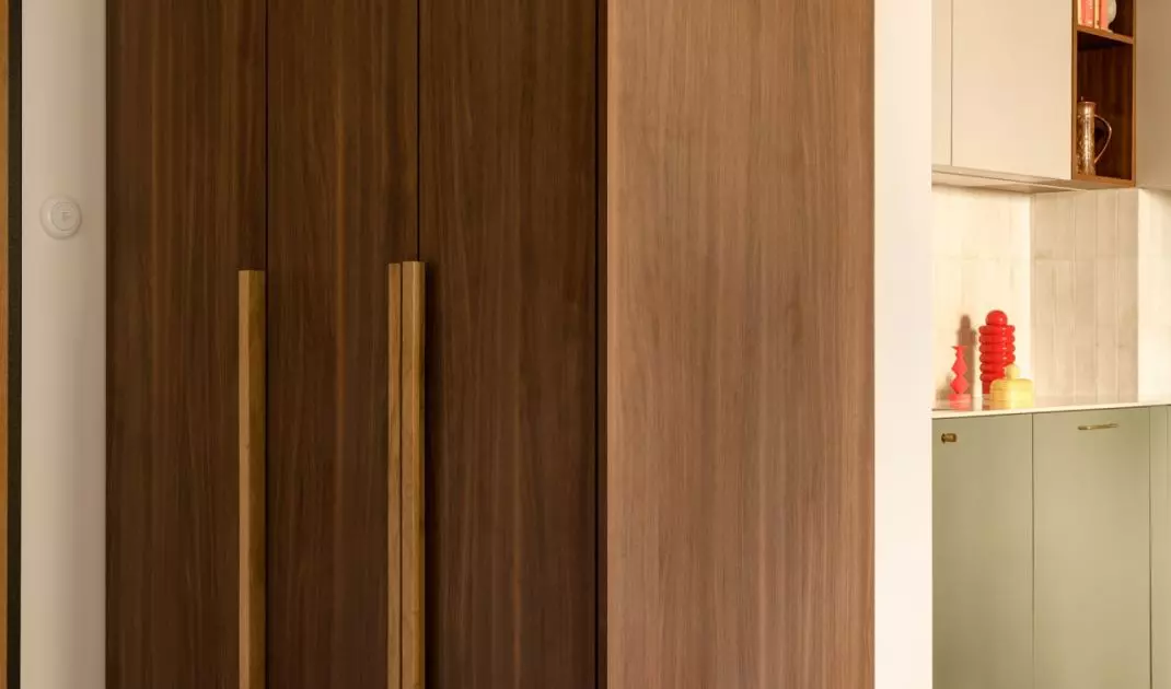 The wooden built-ins in the entryway help organize the space and set the warm tone for the entire apartment