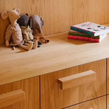 Wooden built-ins help organize the space, while small items give it a more personal touch