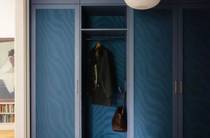 The hallway serves as a dark passageway leading us to bright, colorful rooms
