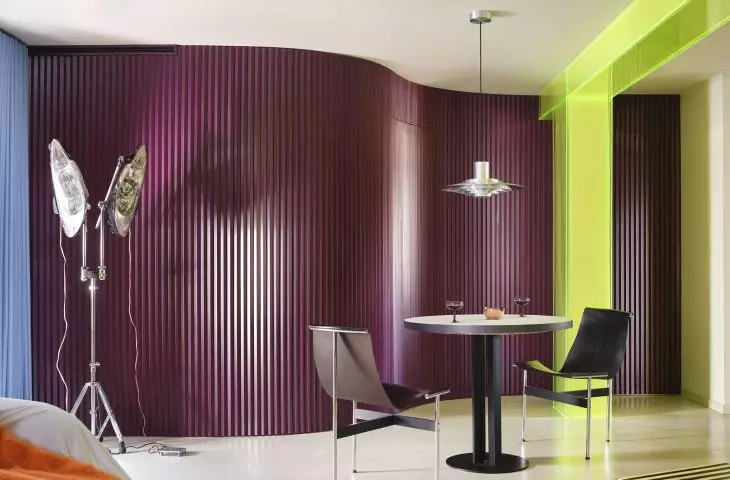 The eggplant-colored wall gives the dining room a theatrical feel and creates a striking backdrop for the table