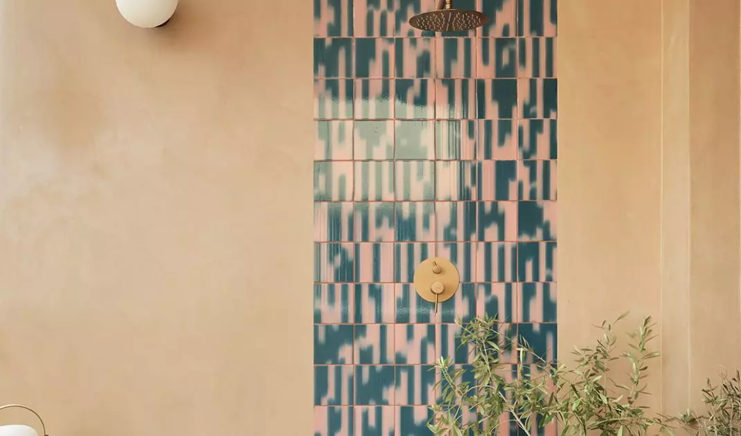 The terrace features patterned tiles, plants, and warm tones that soften the intensity of the interior