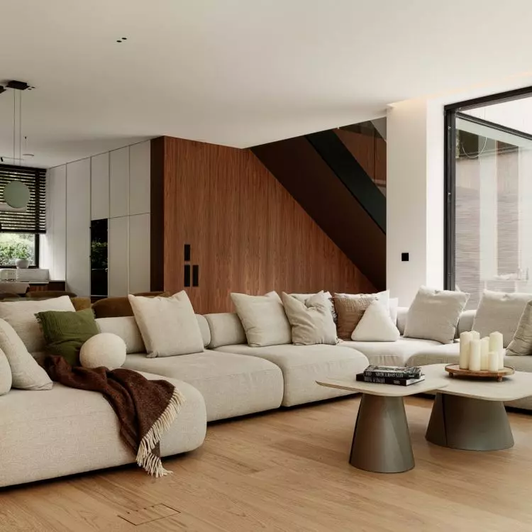 A soft, modular sofa and large windows create a serene atmosphere in the living room, which opens onto the garden