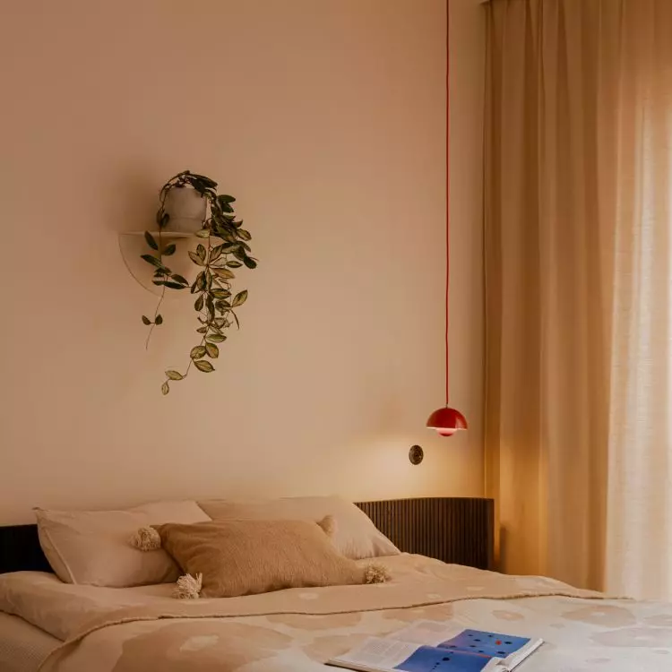 The bedroom features a light, soothing color palette