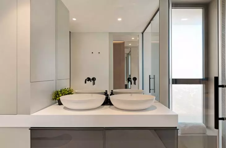 The bathroom features a minimalist, modern design