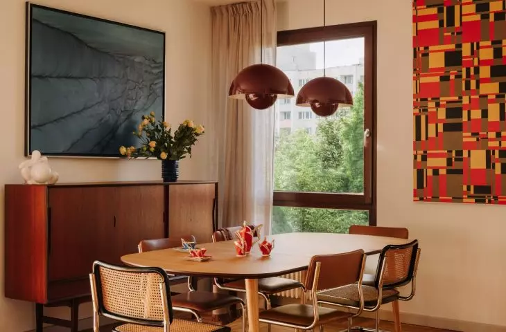 In the dining room, vintage furniture serves as a backdrop for works from the owners' collection