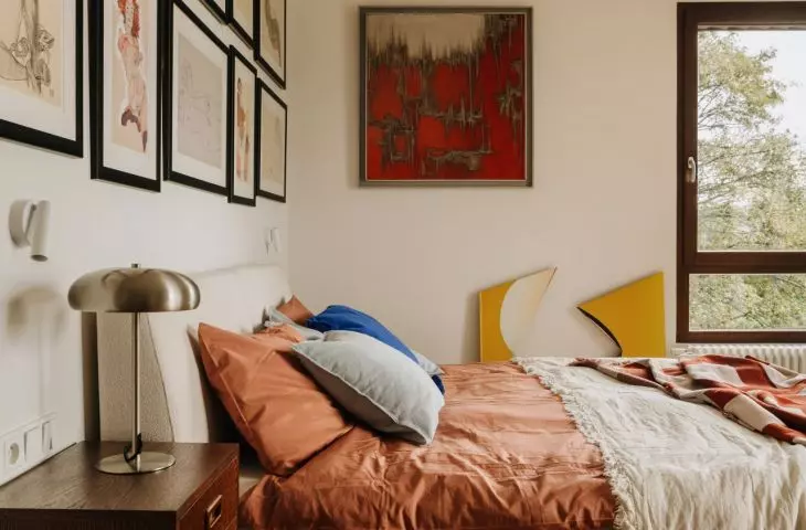 This Wrocław apartment, designed by Buduar, combines art, vintage furniture, and warm, bold colors