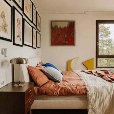 This Wrocław apartment, designed by Buduar, combines art, vintage furniture, and warm, bold colors