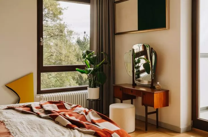 This Wrocław apartment, designed by Buduar, combines art, vintage furniture, and warm, bold colors