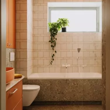 This Wrocław apartment, designed by Buduar, combines art, vintage furniture, and warm, bold colors