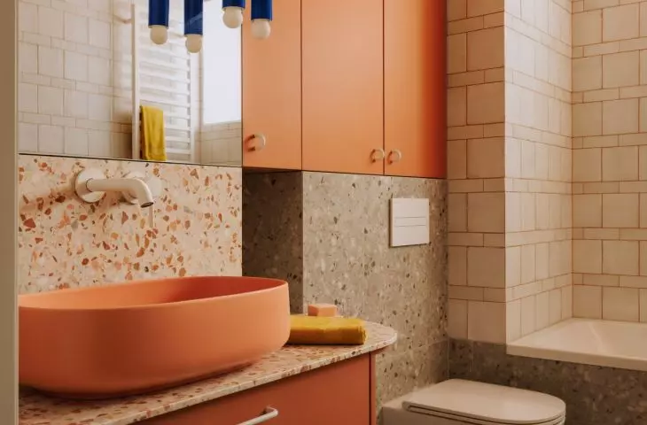 This Wrocław apartment, designed by Buduar, combines art, vintage furniture, and warm, bold colors