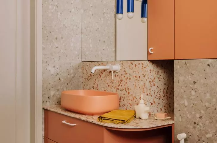 This Wrocław apartment, designed by Buduar, combines art, vintage furniture, and warm, bold colors