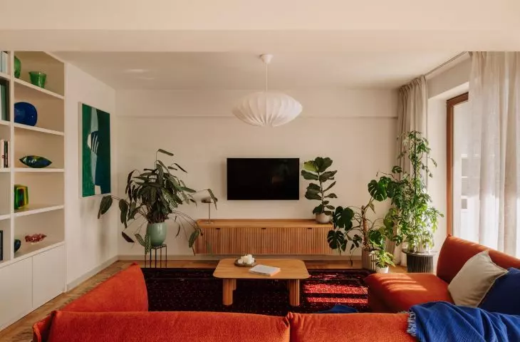 This Wrocław apartment, designed by Buduar, combines art, vintage furniture, and warm, bold colors