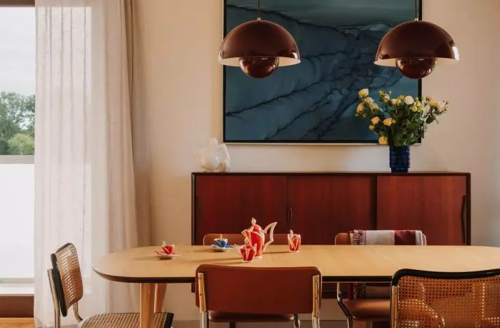 This Wrocław apartment, designed by Buduar, combines art, vintage furniture, and warm, bold colors