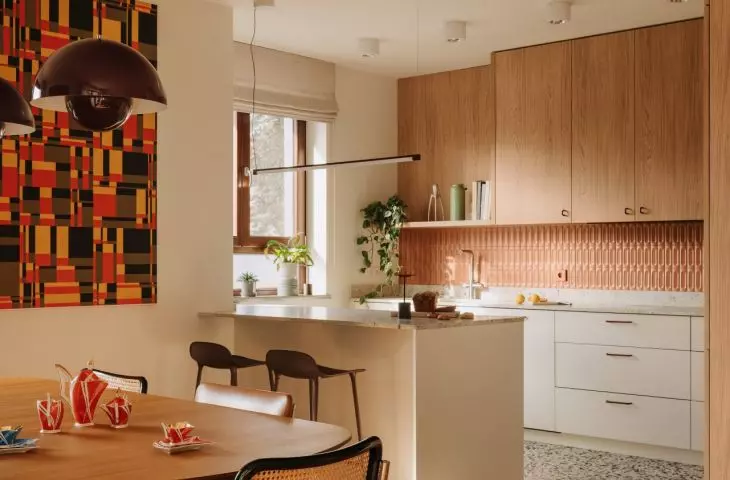 This Wrocław apartment, designed by Buduar, combines art, vintage furniture, and warm, bold colors