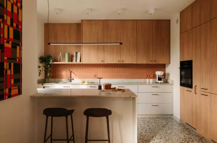This Wrocław apartment, designed by Buduar, combines art, vintage furniture, and warm, bold colors
