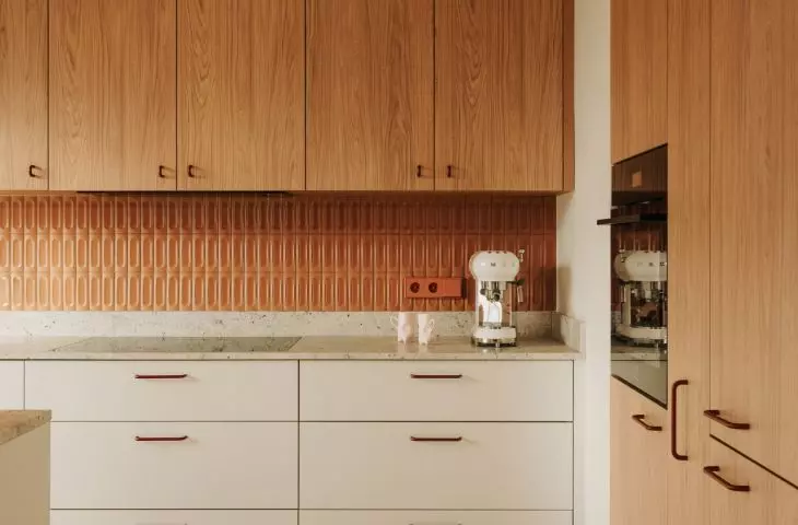 This Wrocław apartment, designed by Buduar, combines art, vintage furniture, and warm, bold colors