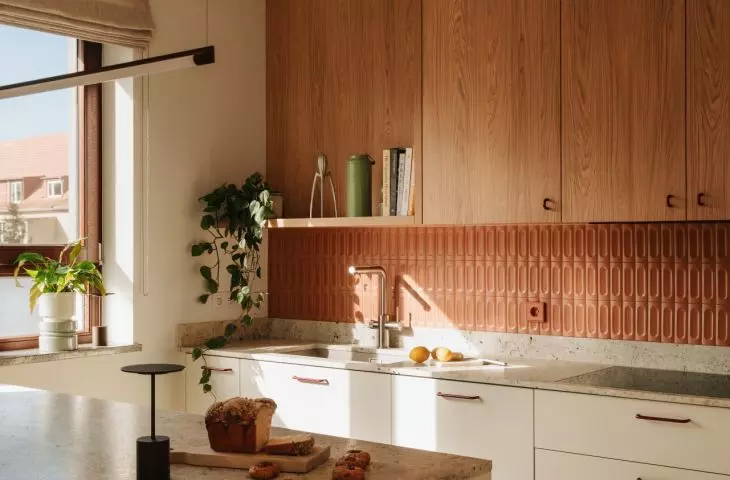 This Wrocław apartment, designed by Buduar, combines art, vintage furniture, and warm, bold colors