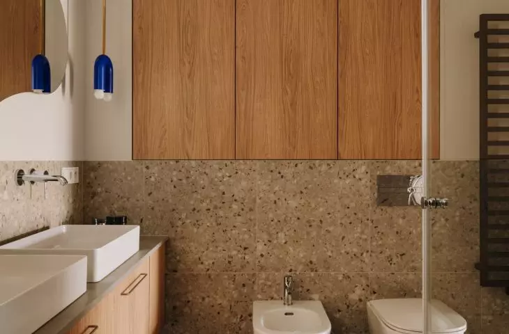 This Wrocław apartment, designed by Buduar, combines art, vintage furniture, and warm, bold colors
