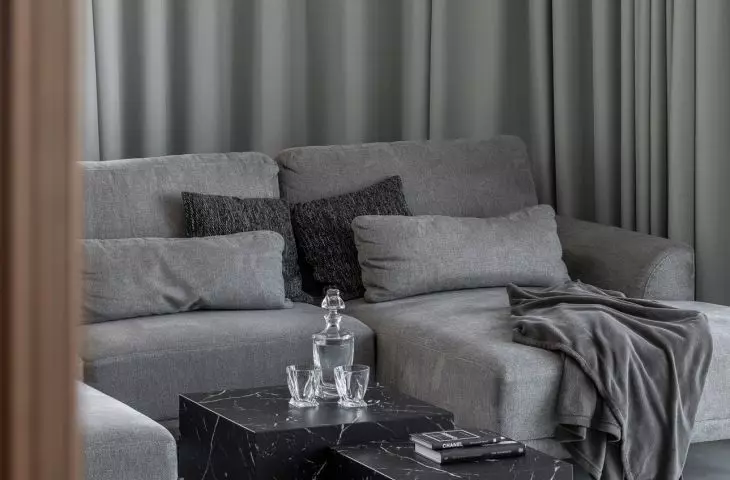 The living room features a calm, monochromatic color scheme