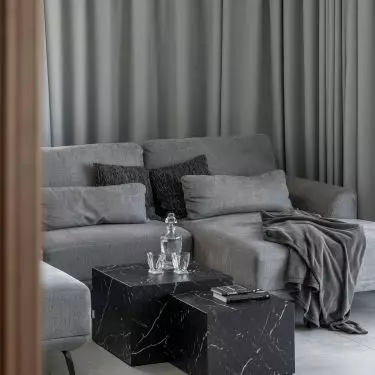The living room features a calm, monochromatic color scheme