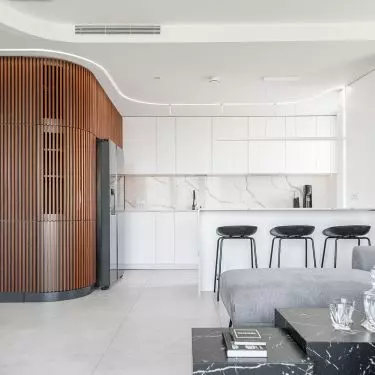 The wooden, sculptural structures define the open living area