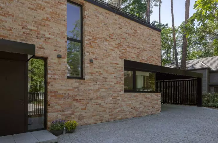 The corner window above the kitchen counter brings in side light and frames the view of the greenery
