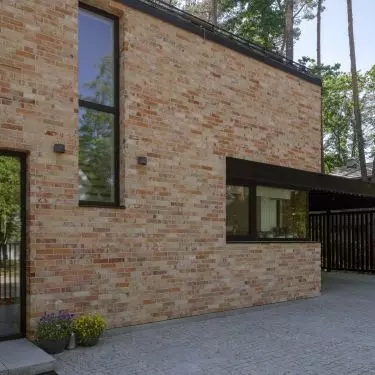 The corner window above the kitchen counter brings in side light and frames the view of the greenery