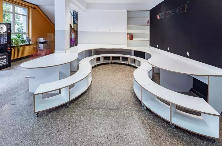 The space is complemented by shelves and a school board
