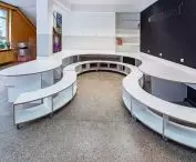 The space is complemented by shelves and a school board