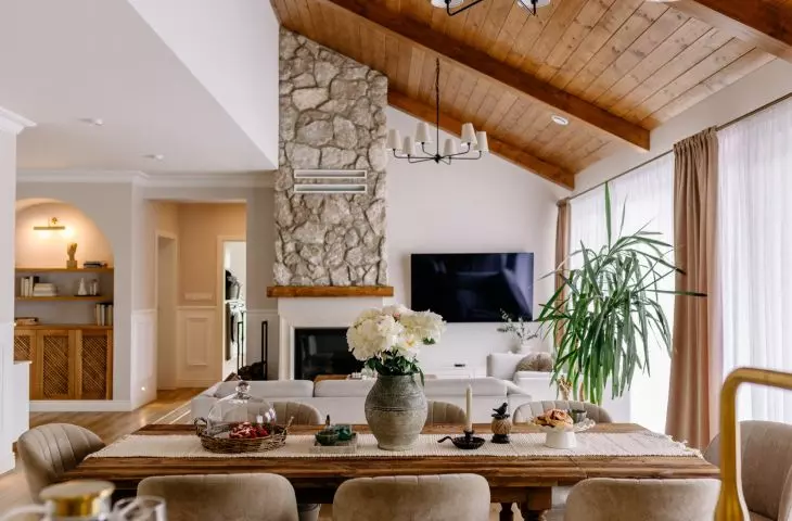 A wooden table defines the dining area, which seamlessly connects the kitchen to the living area