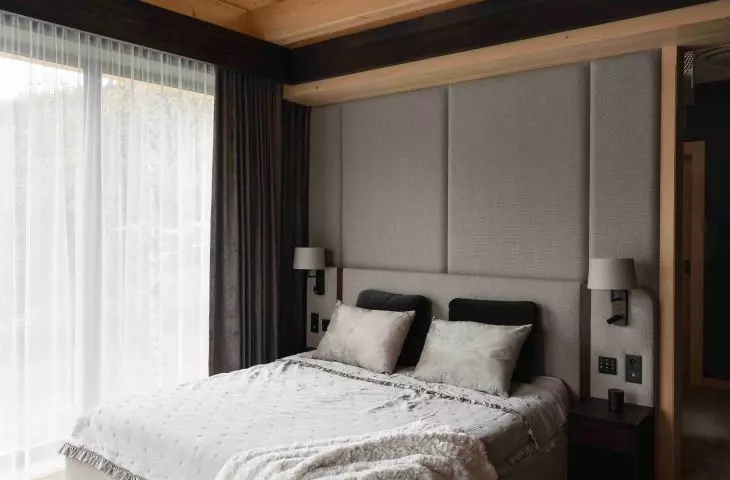 The owners' bedroom, with large windows that open the interior up to the Beskid landscape