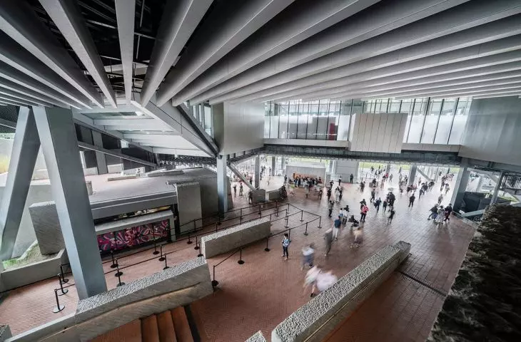 The public space beneath the museum's main structure serves as an extension of the city's streets and squares