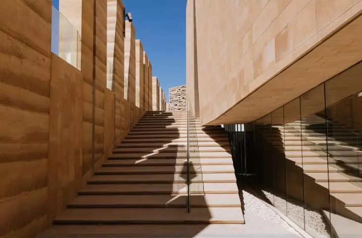 The narrow passageways and stairways between the buildings evoke the layout of the streets in historic Ad-Dirijja