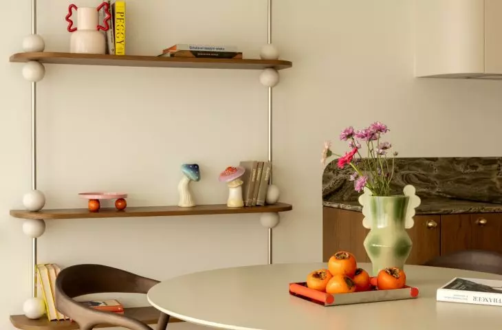 The sphere motif reappears in the bookcase's design and decorative details