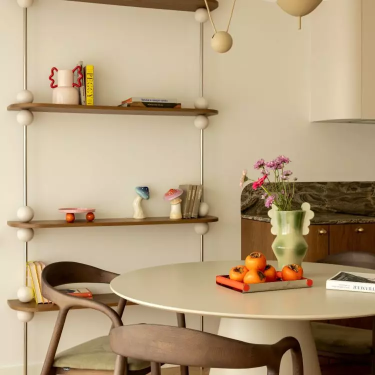 The sphere motif reappears in the bookcase's design and decorative details