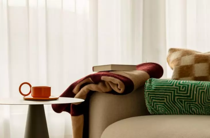 The curved sofa highlights the soft, flowing design language found throughout the apartment