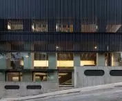 Przeszklony parter otwiera budynek na ulicę, a wyższe piętra osłania metalowa fasada